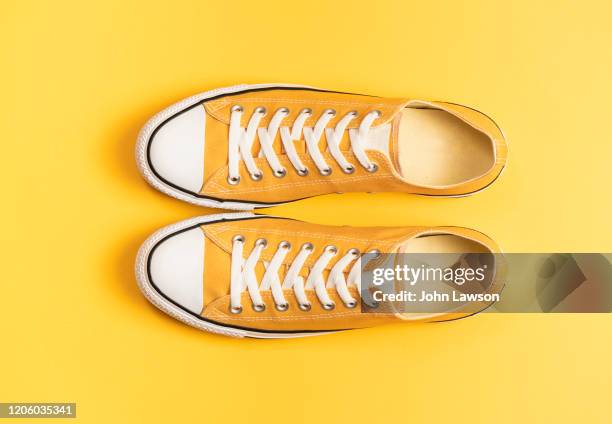 yellow sneakers - yellow shoe stock pictures, royalty-free photos & images