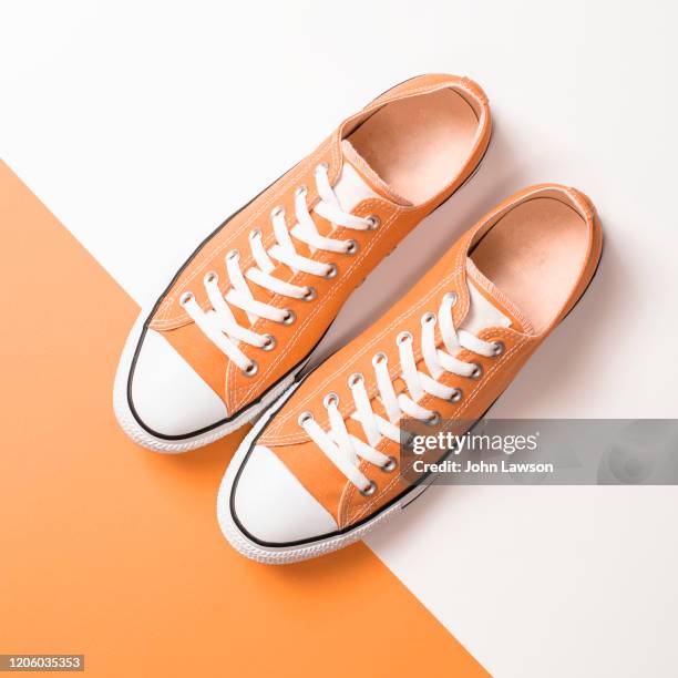 tangerine sneakers - orange shoe stock-fotos und bilder