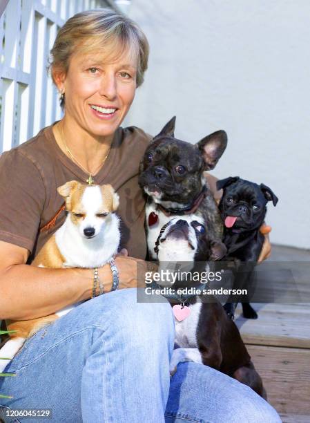 Legendary tennis champion Martina Navratilova with her four dogs outside her home in Nokomis, Florida in November 2004.