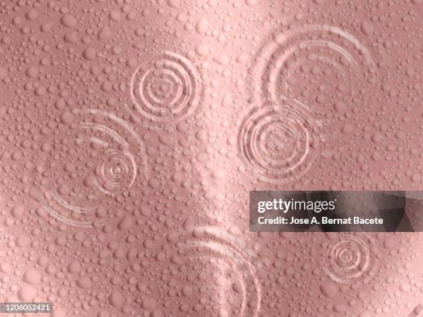 rainwater drops on a pink background. - rainy season stock pictures, royalty-free photos & images