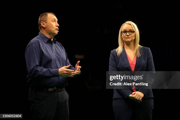 Laura Turner stands on stage with Wayne Mardle prior to day two of the Unibet Premier League at Motorpoint Arena on February 13, 2020 in Nottingham,...