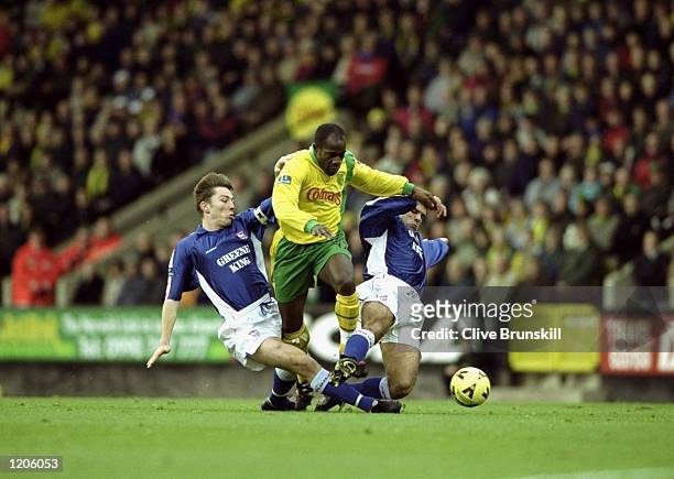 Adrian Forbes of Norwich City skips over the lunges from Matt Holland and Mick Stockwell of Ipswich Town during the Nationwide League Division One...