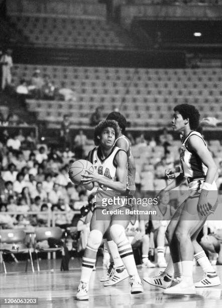 American Cheryl Miller dribbles the ball and looks toward teammate Lynette Woodard in a basketball game against the Cuban team in the 1983...