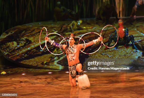 Canadian circus troop "Cirque du Soleil" performs in their acrobatic performance during the premiere of "Totem" by Cirque du Soleil at Theresienwiese...