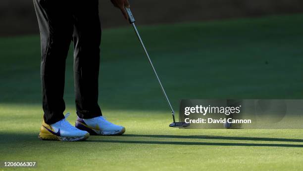 Brooks Koepka of the United States putts on the par 4, 13th hole wearing a special pair of 'Mamba' golf shoes to remember Kobe Bryant during the...