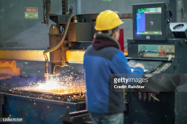 portrait of an employee working on the production line - cutting stock pictures, royalty-free photos & images