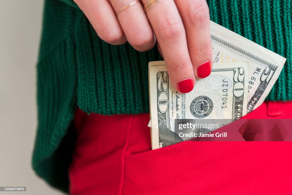 Woman putting money in pocket