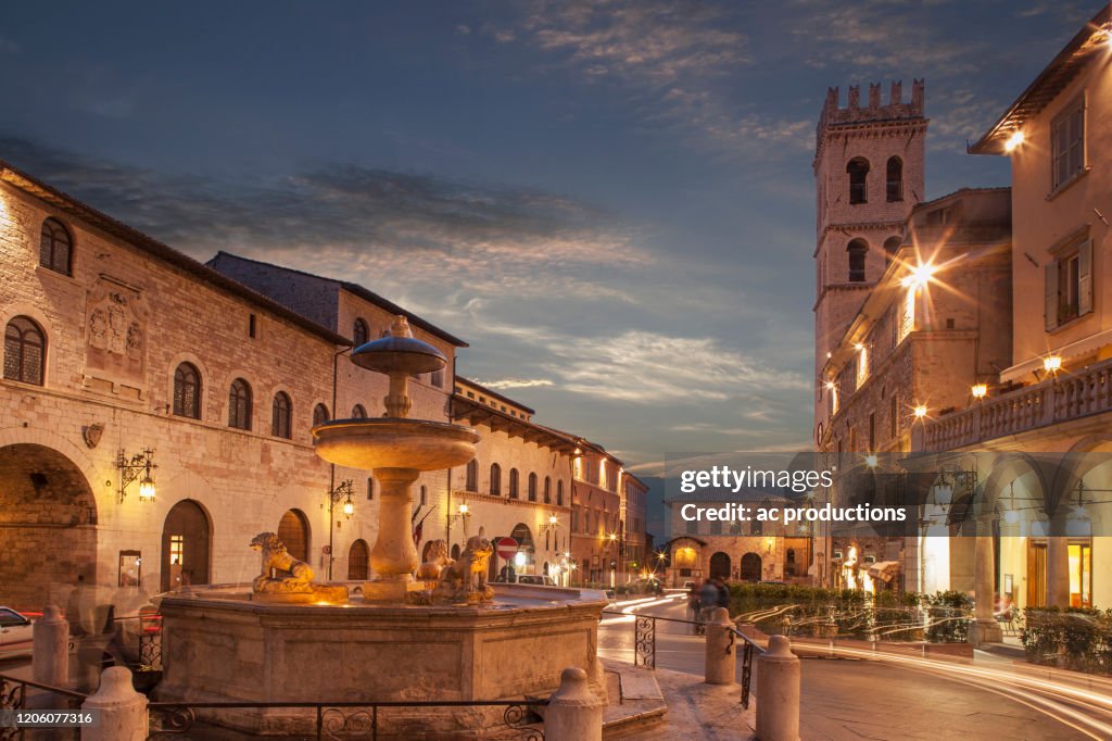 Fountain in Piazza del Comune at sunset in Assisi, Italy