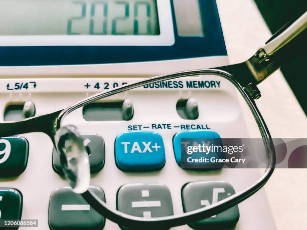 close-up of keys on business and tax calculator - irc imagens e fotografias de stock