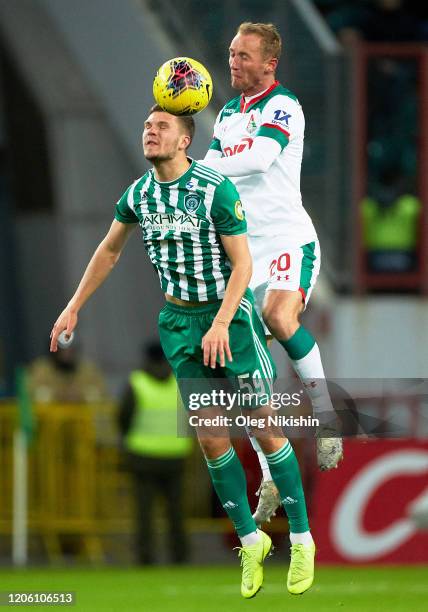 Vladislav Ignatyev of FC Lokomotiv Moscow and Yevgeni Kharin of FC Akhmat Grozny vie for the ball during the Russian Football League match between FC...