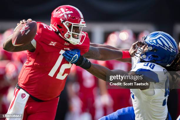 Cardale Jones of the DC Defenders stiff arms Will Clarke of the St. Louis Battlehawks during the first half of the XFL game at Audi Field on March 8,...