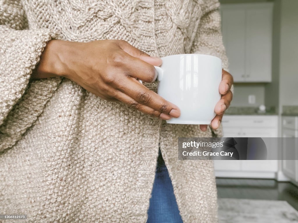 Midsection of Woman Holding Coffee Cup