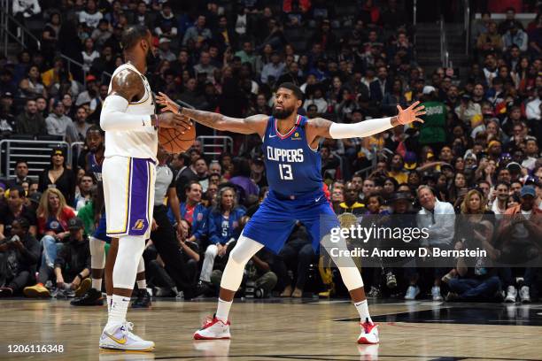 LeBron James of the Los Angeles Lakers handles the ball while Paul George of the LA Clippers plays defense on March 8, 2020 at STAPLES Center in Los...