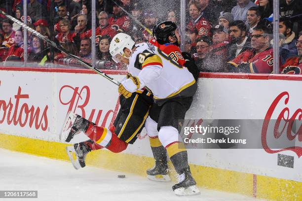 Andrew Mangiapane of the Calgary Flames flies into the boards after missing a check on Jonathan Marchessault of the Vegas Golden Knights during an...