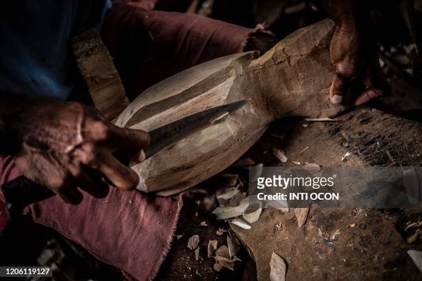 Craftsman sculpts a toucan with raft wood to sell to tourists, in Mancarron Island, at the Solentiname archipielago, Nicaragua, on March 7, 2020. -...
