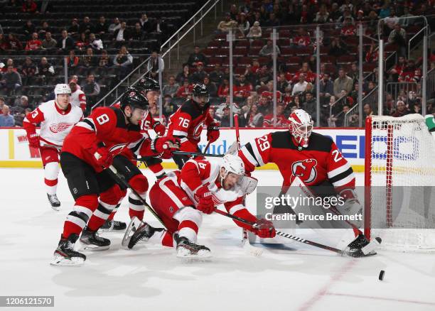 Mackenzie Blackwood of the New Jersey Devils makes the third period save on Justin Abdelkader of the Detroit Red Wings at the Prudential Center on...