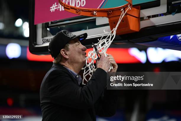 State Wolfpack head coach Wes Moore kisses the net while cutting it down after winning the ACC Women's Tournament Championship game between the...