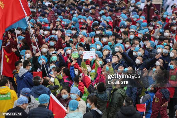 Medical staff celebrate after all patients were discharged at a temporary hospital set up to treat people with the COVID-19 coronavirus in Wuhan in...