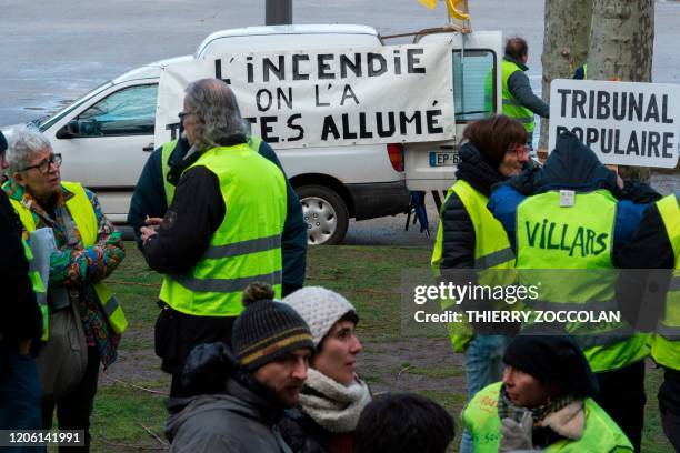 Members of the yellow vest mouvment gather in front of Le Puy-en-Velay courthouse on March 9, 2020 before the trial of four militants accused to have...