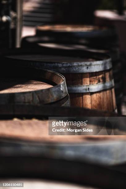 wooden whiskey barrels in selective focus - whisky distillery stock-fotos und bilder