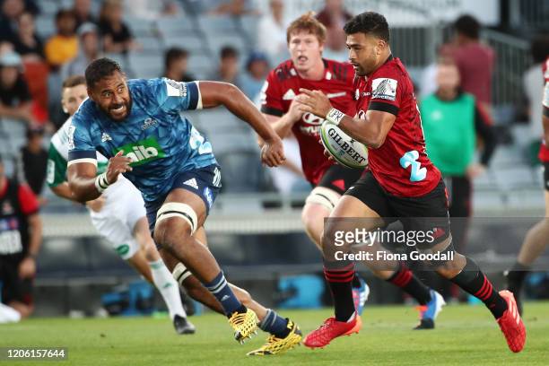 Richie Mo’unga of the Crusaders makes a break with Patrick Tuipulotu, captain of the Blues chasing during the round 3 Super Rugby match between the...