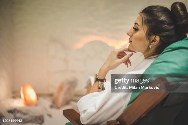 woman relaxing in salt room - himalayan salt stock pictures, royalty-free photos & images