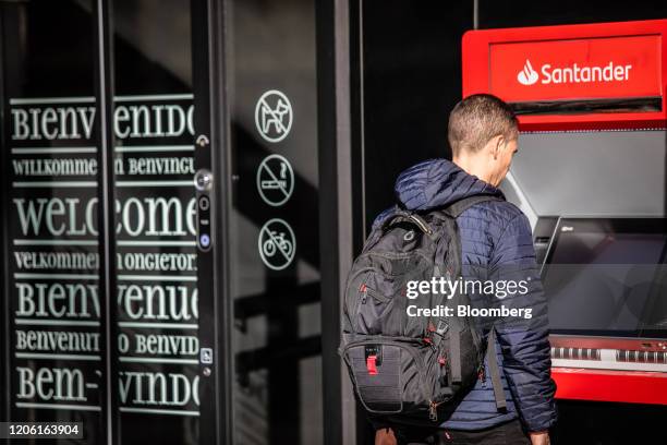 An automated teller machine sits outside the Banco Santander SA Work Cafe co-working space in Barcelona, Spain, on Friday, March 6, 2020. Spanish...