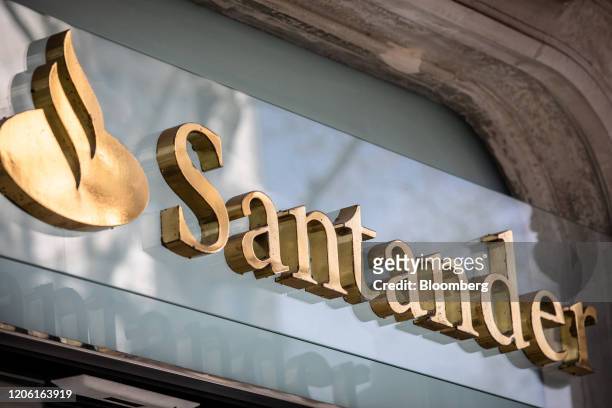 Golden logo sits on display outside a Banco Santander SA bank branch in Barcelona, Spain, on Friday, March 6, 2020. Spanish bank shares soared after...