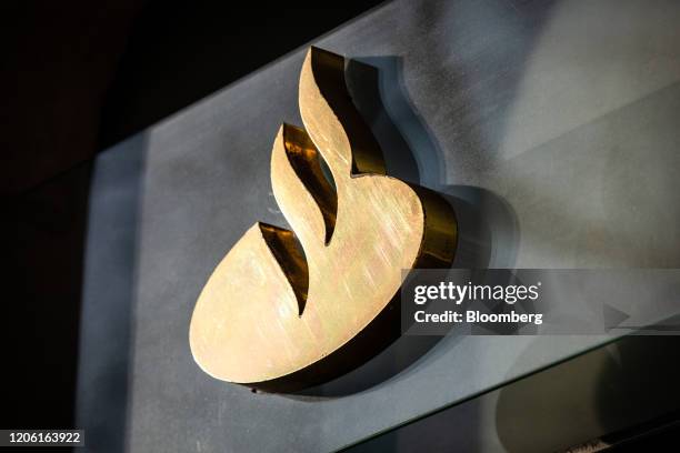 Golden logo sits on display outside a Banco Santander SA bank branch in Barcelona, Spain, on Friday, March 6, 2020. Spanish bank shares soared after...