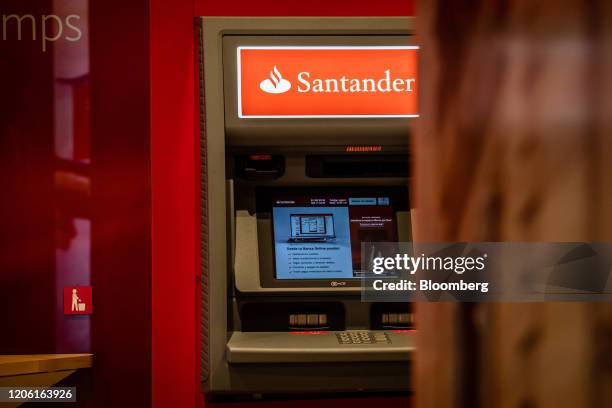 An automated teller machine sits inside a Banco Santander SA bank branch in Barcelona, Spain, on Friday, March 6, 2020. Spanish bank shares soared...