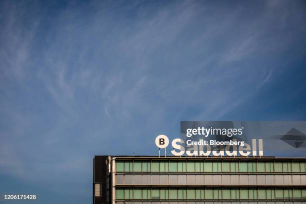 Sign stands on the roof of the Banco de Sabadell SA headquarters in Barcelona, Spain, on Thursday, March 5, 2020. Spanish bank shares soared after...