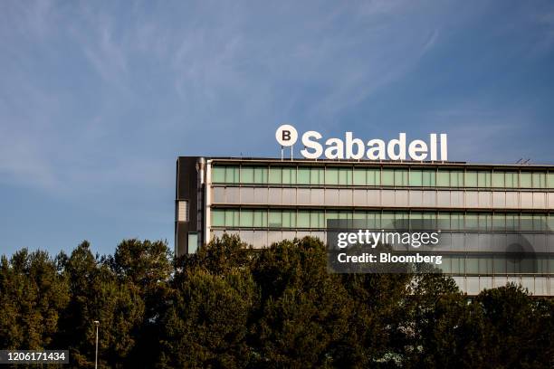 Sign stands on the roof of the Banco de Sabadell SA headquarters in Barcelona, Spain, on Thursday, March 5, 2020. Spanish bank shares soared after...