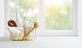 Eco-friendly natural cleaning products on table and window background