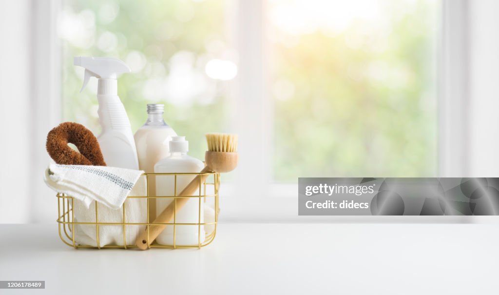 Eco-friendly natural cleaning products on table and window background