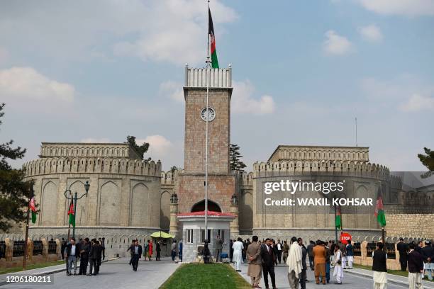 Officials gather at an entrance ahead of the start of Afghanistan President Ashraf Ghani's swearing-in inauguration ceremony, at the Presidential...