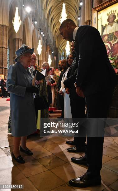 Queen Elizabeth II talks with British boxer Anthony Joshua as she leaves after attending the Commonwealth Day Service 2020 on March 9, 2020 in...
