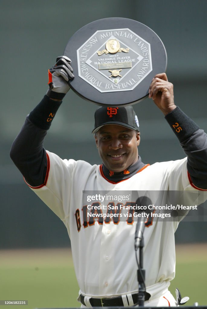 Barry Bonds holds up his MVP award in a ceremony before the home opener.