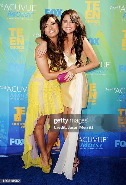 Singer/actresses Demi Lovato and Selena Gomez arrive at the 2011 Teen Choice Awards held at the Gibson Amphitheatre on August 7, 2011 in Universal...