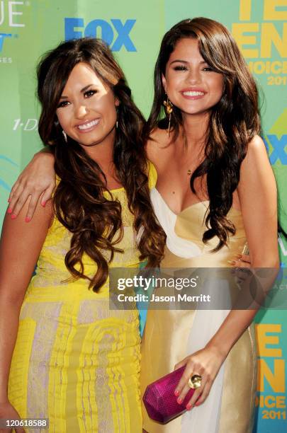 Singer/actresses Demi Lovato and Selena Gomez arrive at the 2011 Teen Choice Awards held at the Gibson Amphitheatre on August 7, 2011 in Universal...