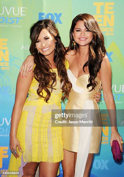 Singer/actresses Demi Lovato and Selena Gomez arrive at the 2011 Teen Choice Awards held at the Gibson Amphitheatre on August 7, 2011 in Universal...