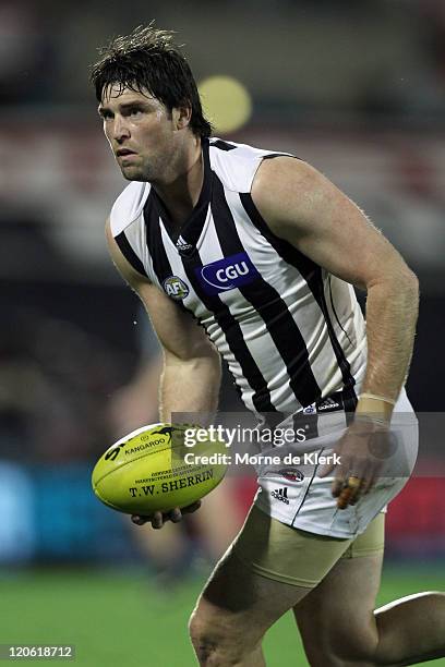 Leigh Brown of the Magpies runs with the ball during the round 20 AFL match between the Port Adelaide Power and the Collingwood Magpies at AAMI...