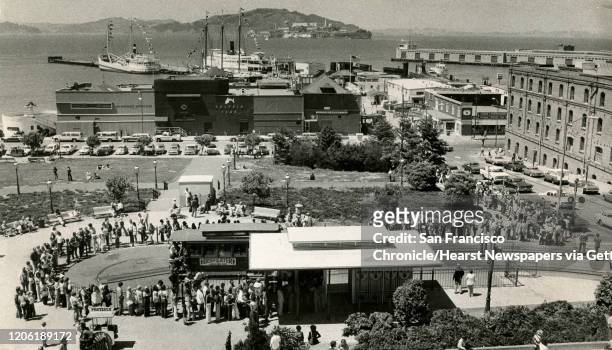 Lines of tourists wait for cable car at Wharf turntable, Victorian Square, from the top of the Buena Vista Cafe. Alcatraz can be seen in the...