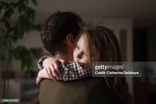 a father and his daughter cuddling at home - girls hugging stock pictures, royalty-free photos & images
