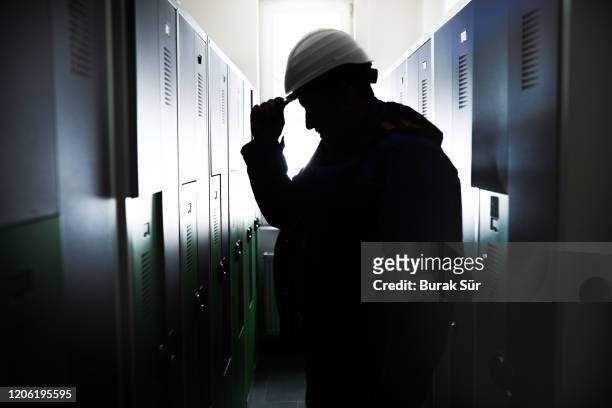 worker silhouette and getting ready in dressing room - miner helmet portrait stock pictures, royalty-free photos & images