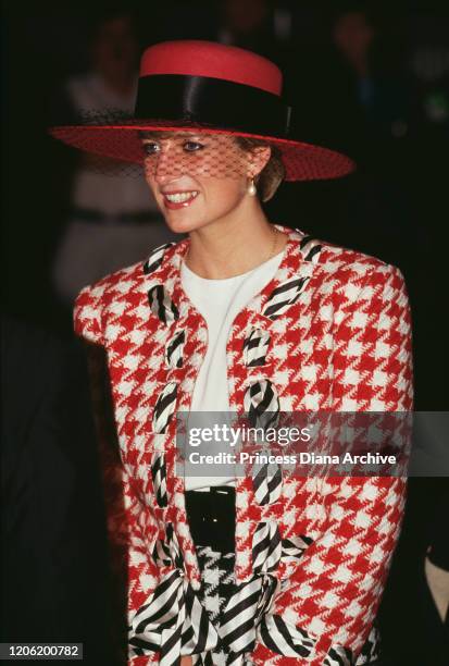 Diana, Princess of Wales arrives at Toronto airport for an official visit to Canada, 23rd October 1991. She is wearing a red, white and black...