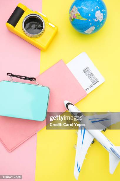 modern airplane, passport, and travel items.pastel background - toy camera stock pictures, royalty-free photos & images