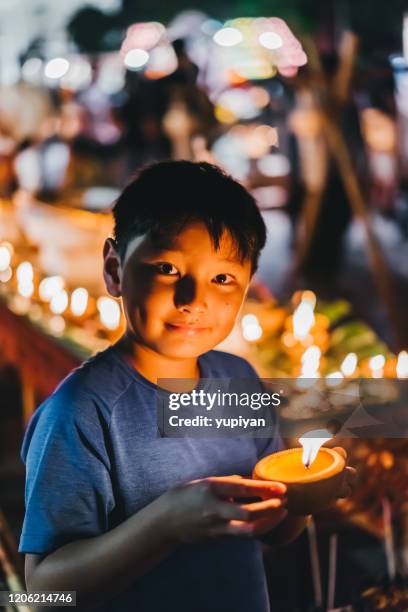 boy light up candle in loy krathong - light to night festival 2018 stock pictures, royalty-free photos & images