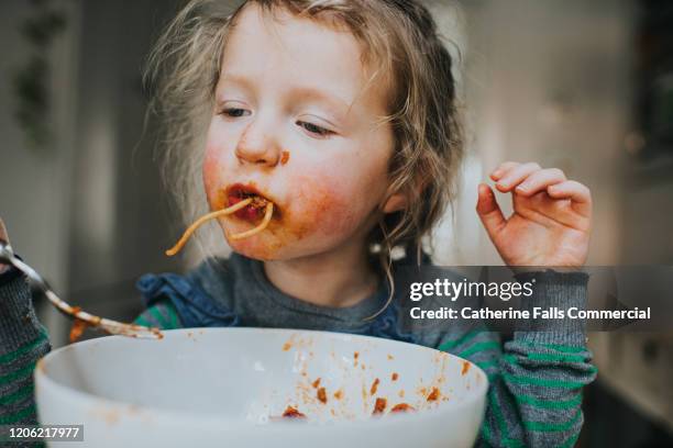 child eating spaghetti - spaghetti bolognese fotografías e imágenes de stock