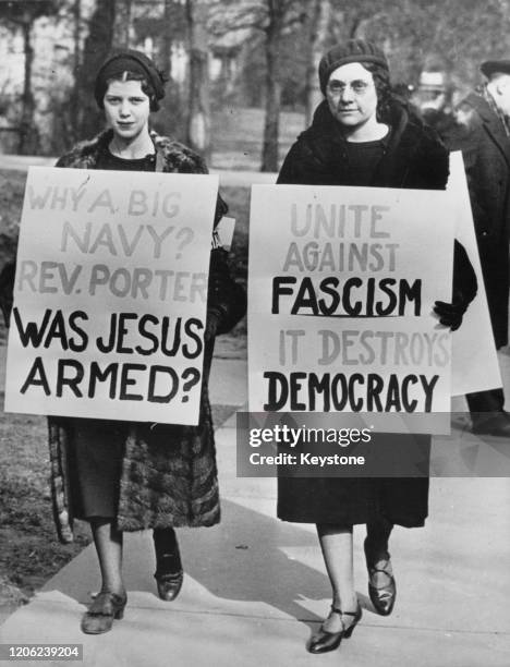 Gloria Waldron and Helen Meyer , members of the Young People's Socialist League of St Louis, protest against pastor Dr Robert Porter holding placards...
