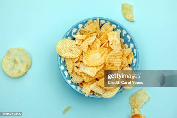 potato chips top view.turqoise background - snack bowl stock pictures, royalty-free photos & images